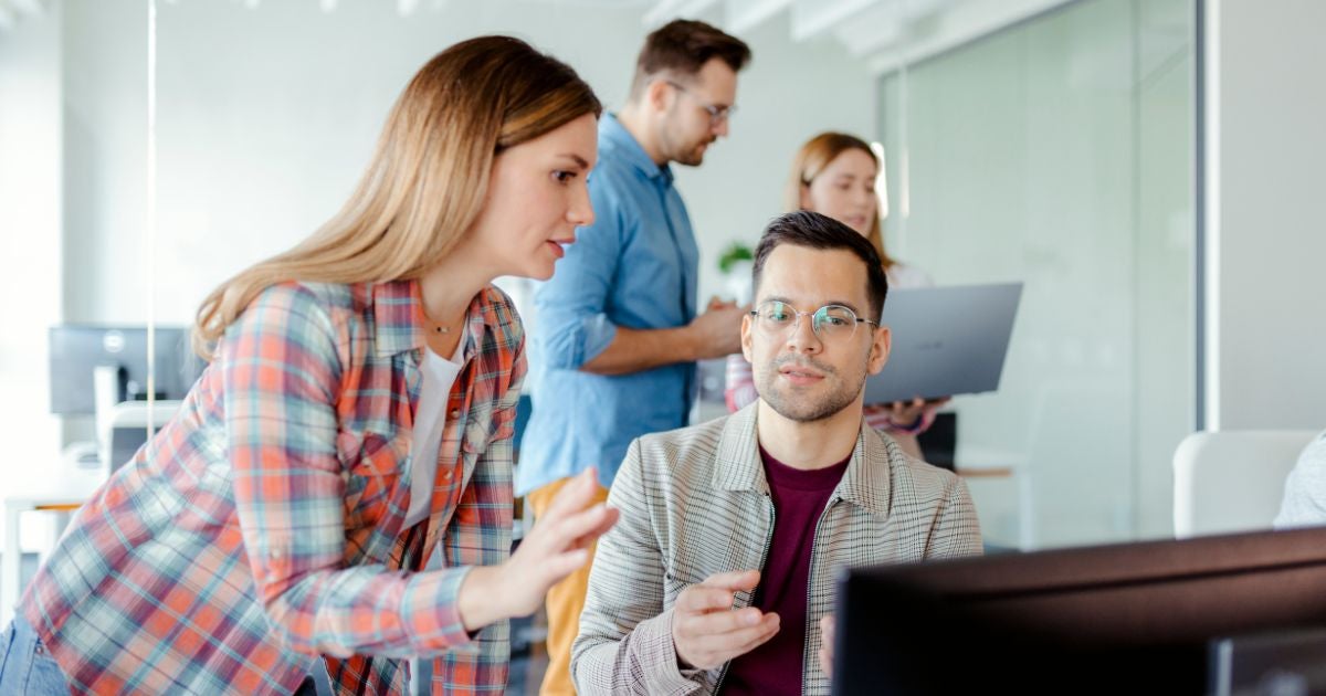 penetration tester working in the office with coworkers